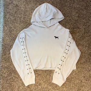 a white cropped PINK hoodie